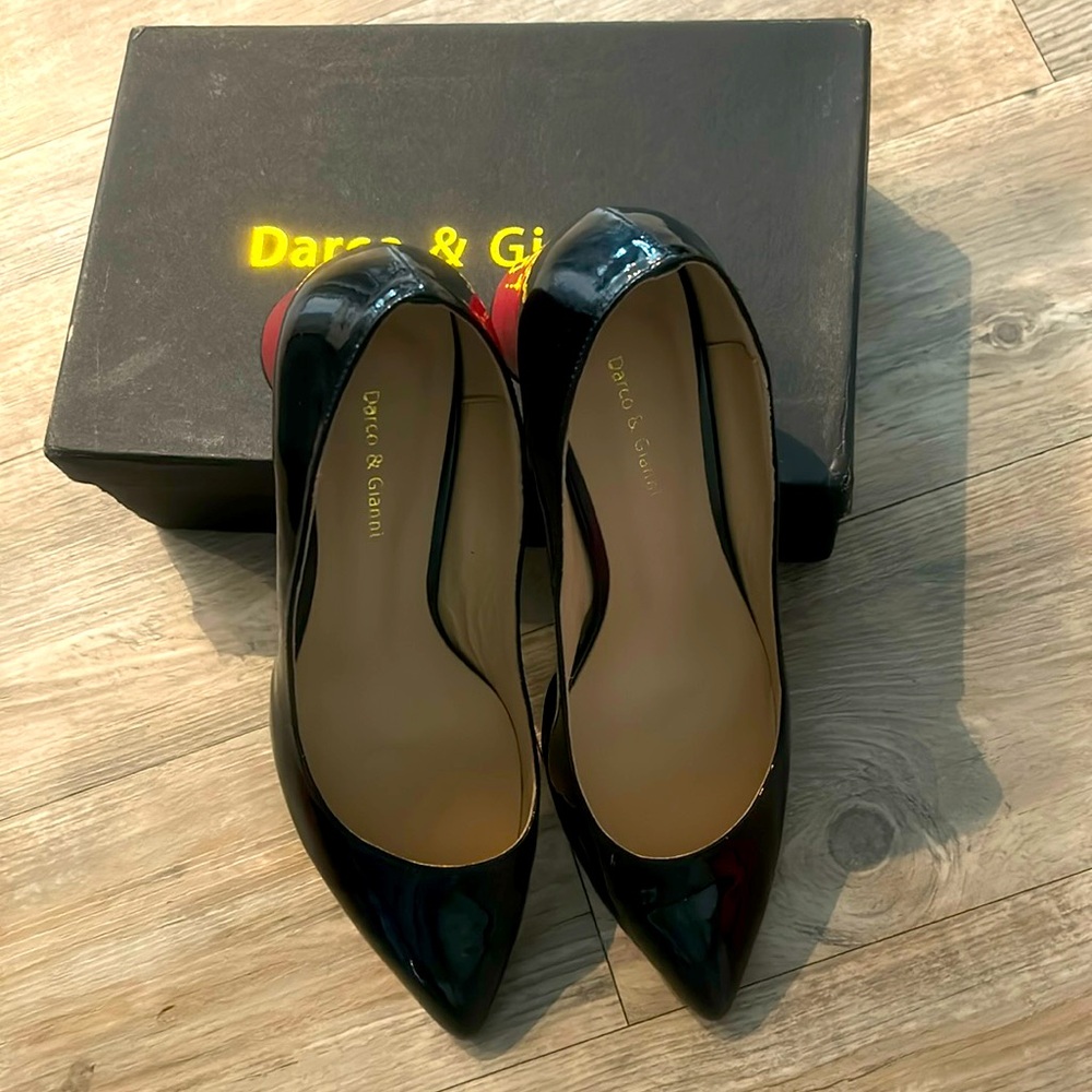 Black patent dress shoes with red patent heels